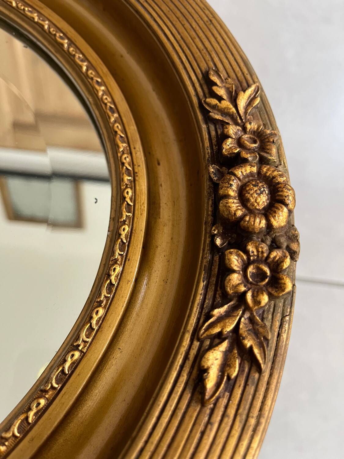 Oval gilt mirror and Art Deco trim