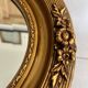 Oval gilt mirror and Art Deco trim