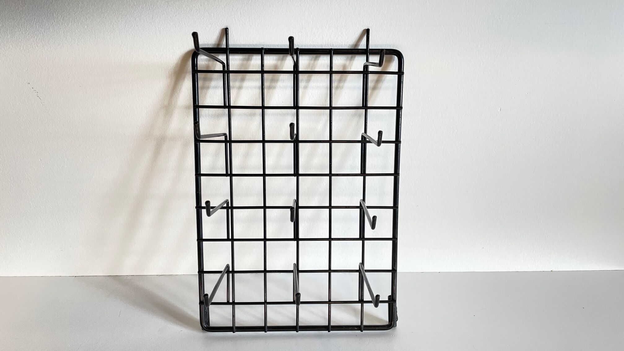 Vintage black metal wall loom display
