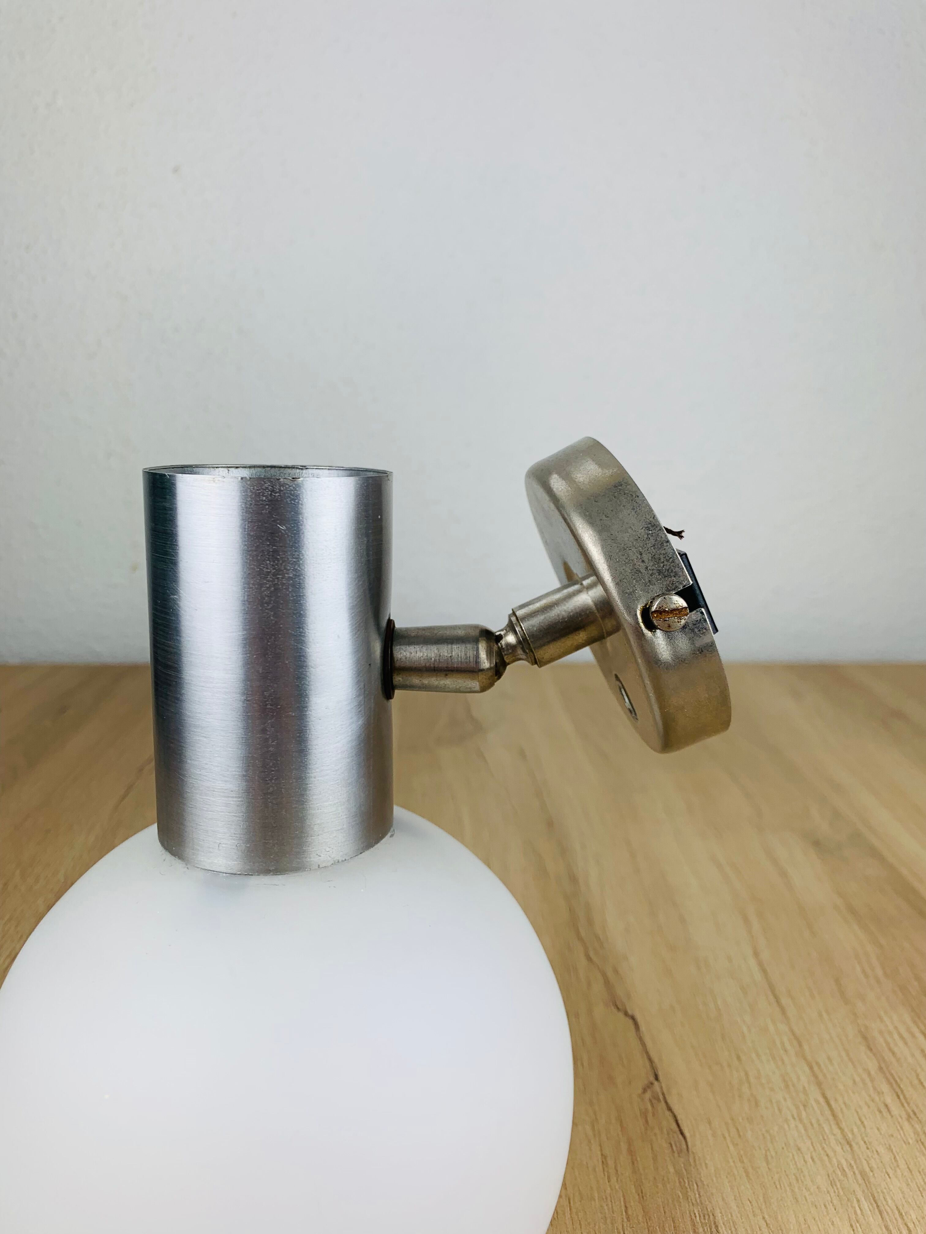 Space age opaline globe wall light, adjustable, and brushed metal, 1960s.