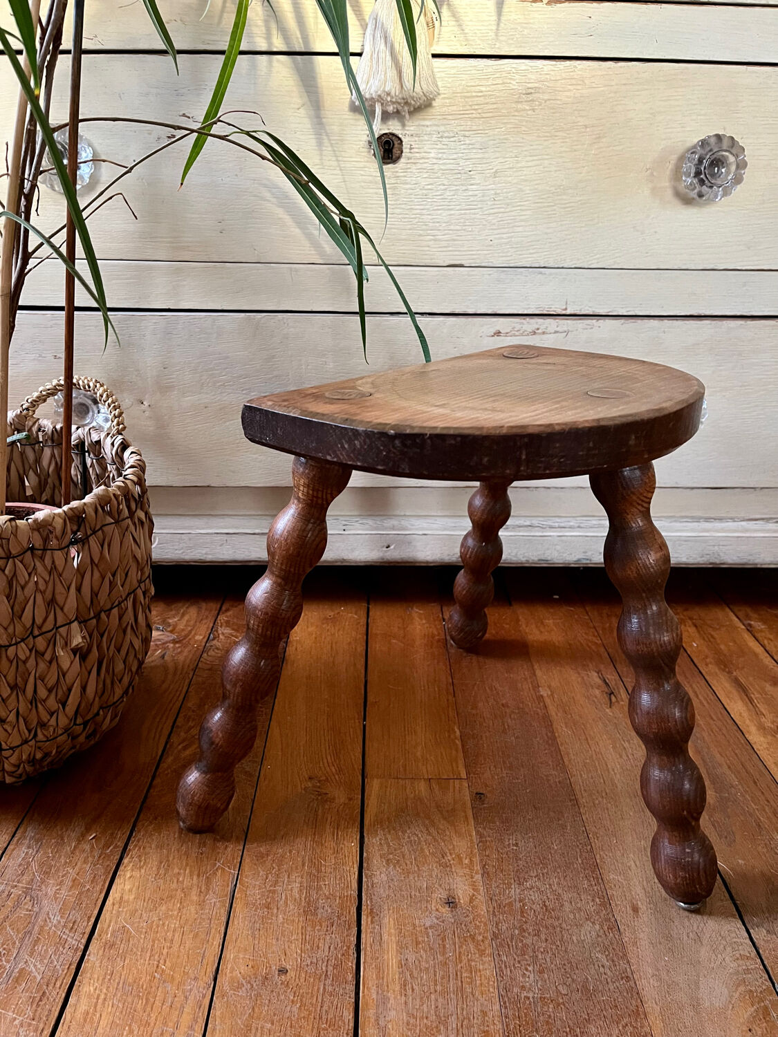 Low vintage wooden tripod stool