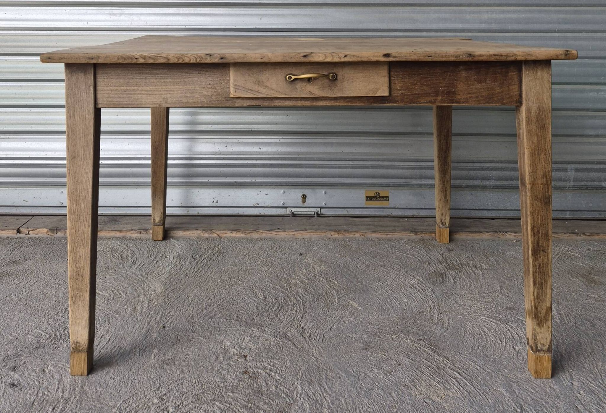Old farmhouse table with its 2 extensions and raised legs.