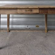 Old farmhouse table with its 2 extensions and raised legs.