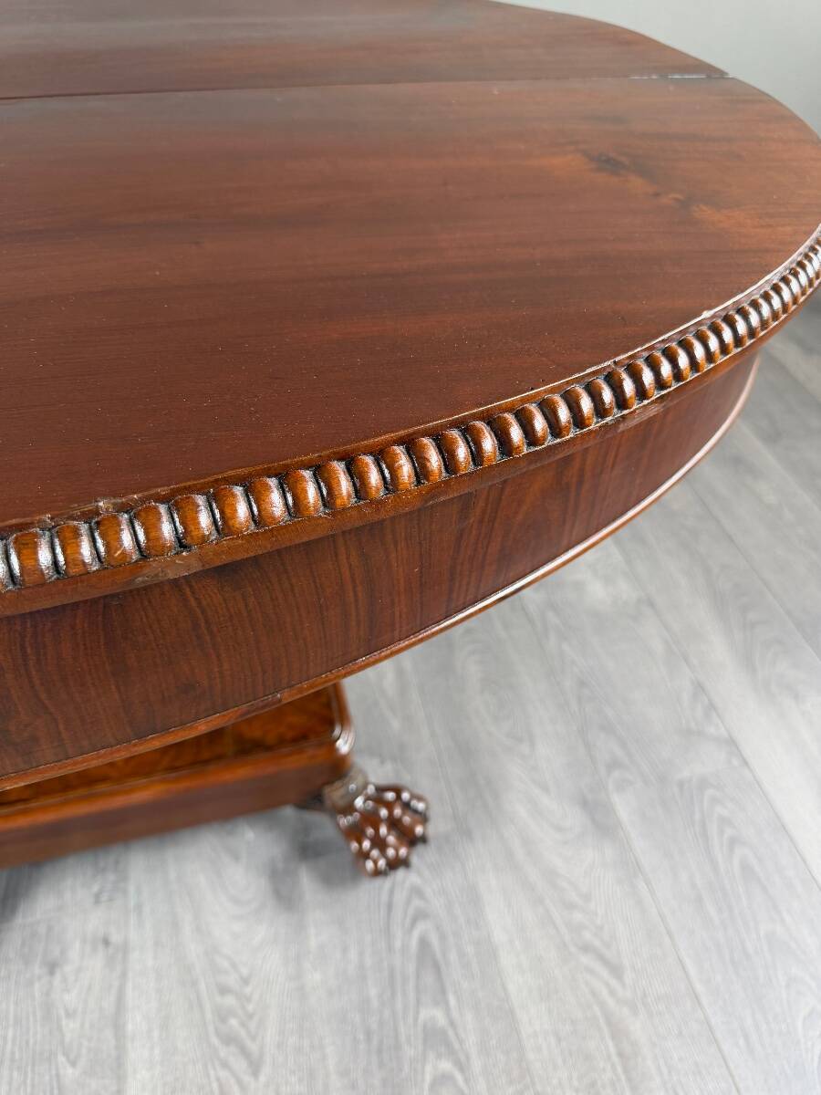 Oval Empire-style table with a central pedestal, 19th century.