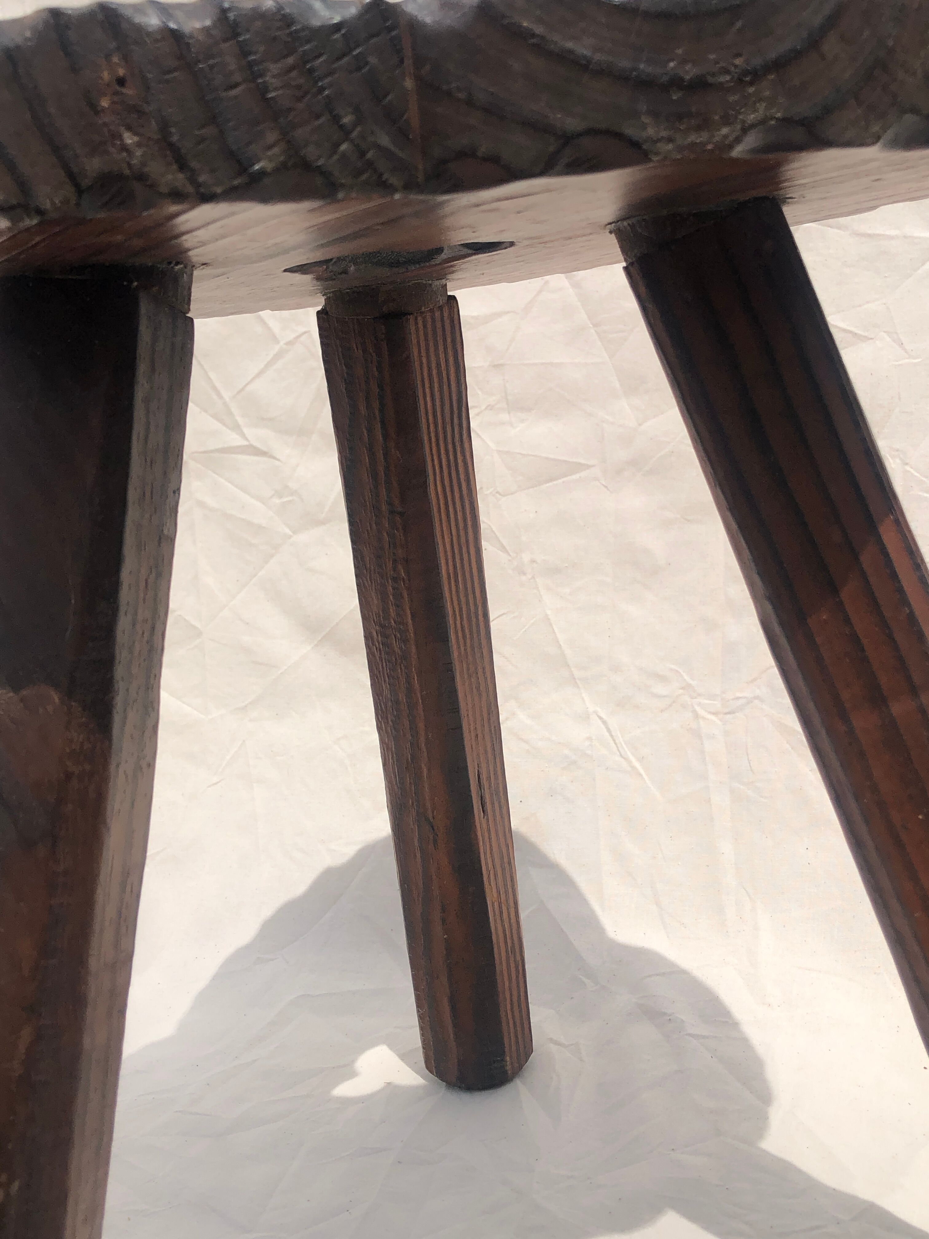 Chiseled wooden tripod stool
