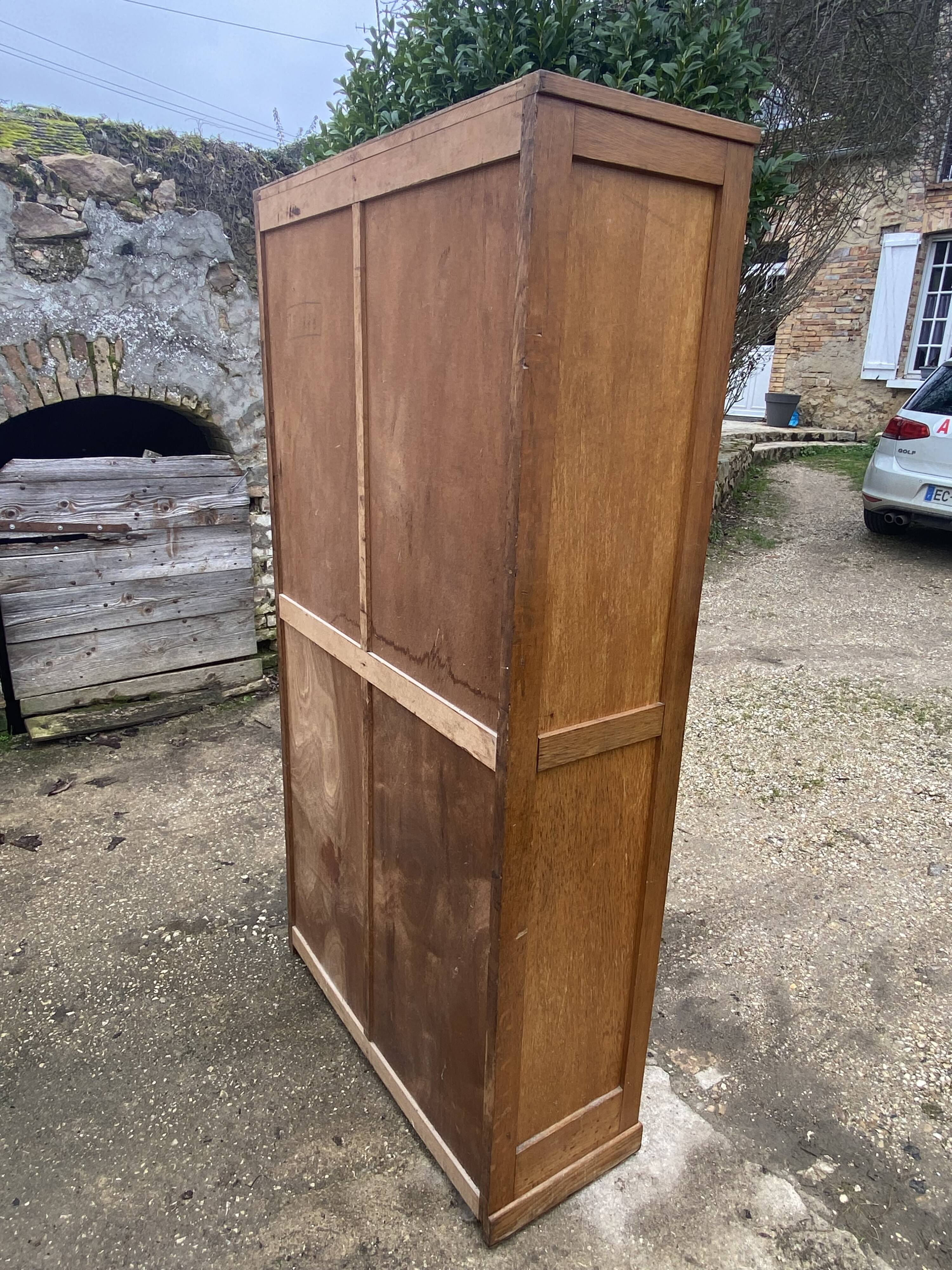 Double-column oak filing cabinet with curtains, 1950s.