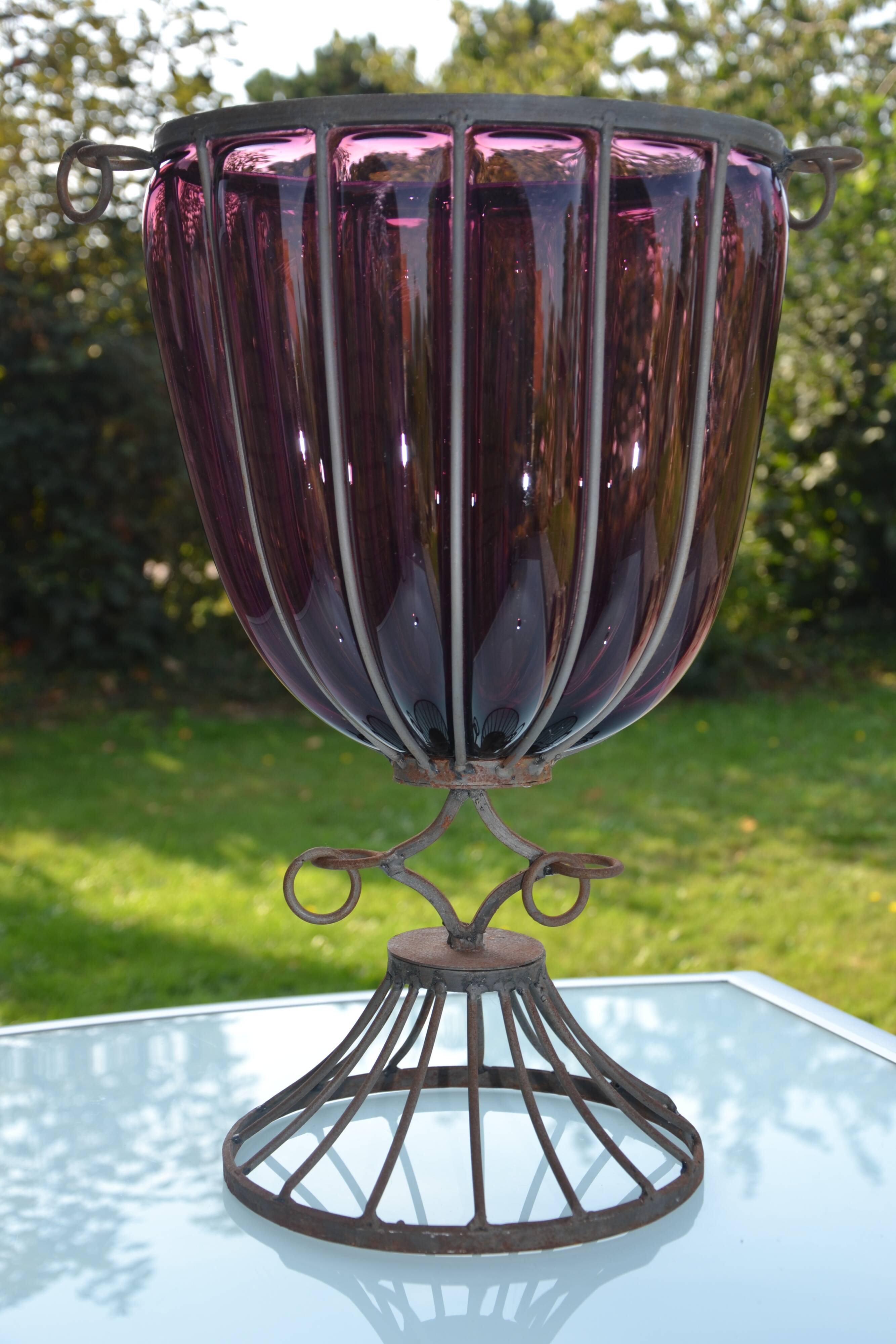 Large blown glass and wrought iron vase on shower stand