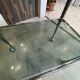 Serving dessert trolley with 2 smoked glass shelves and metal structure.