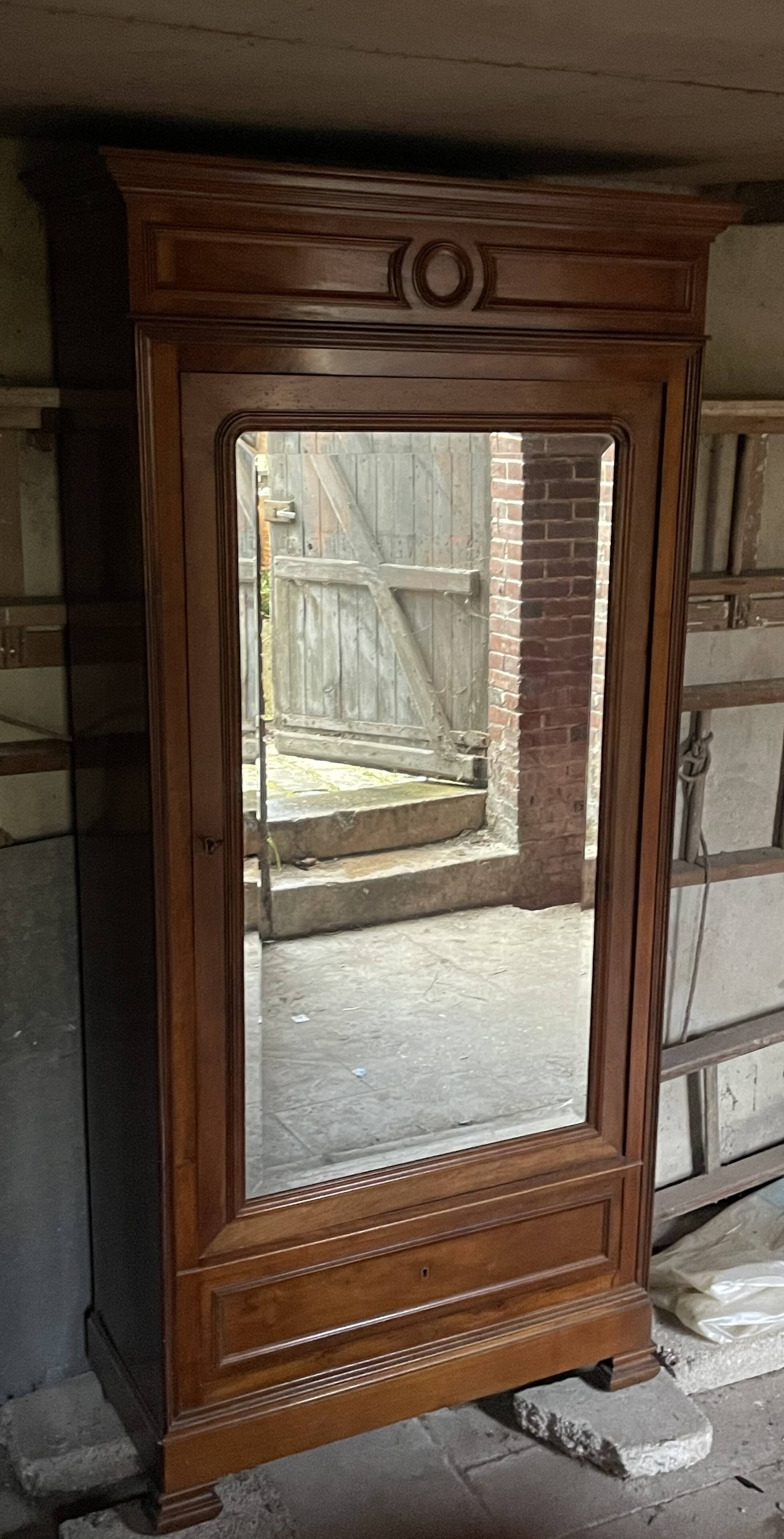 Antique wardrobe with a mirror door.