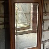 Antique wardrobe with a mirror door.