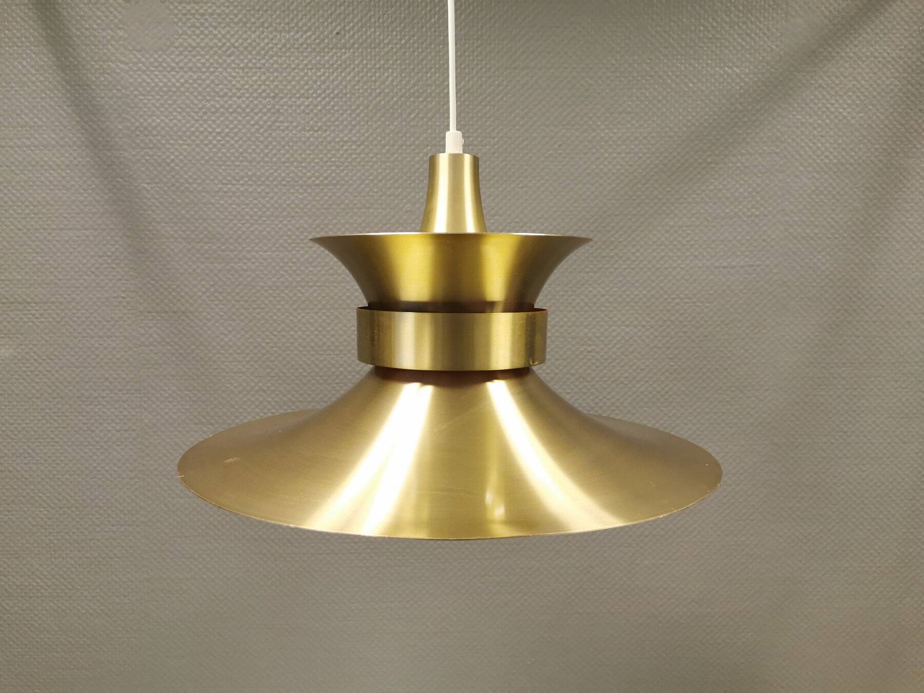 Large hanging lamp, made of brass-coloured aluminium with red and white contrast lacquer inside.