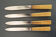Set de 4 anciens couteaux de table inox et bakelite
