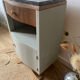 Pair of mismatched art deco bedside tables in green and wood