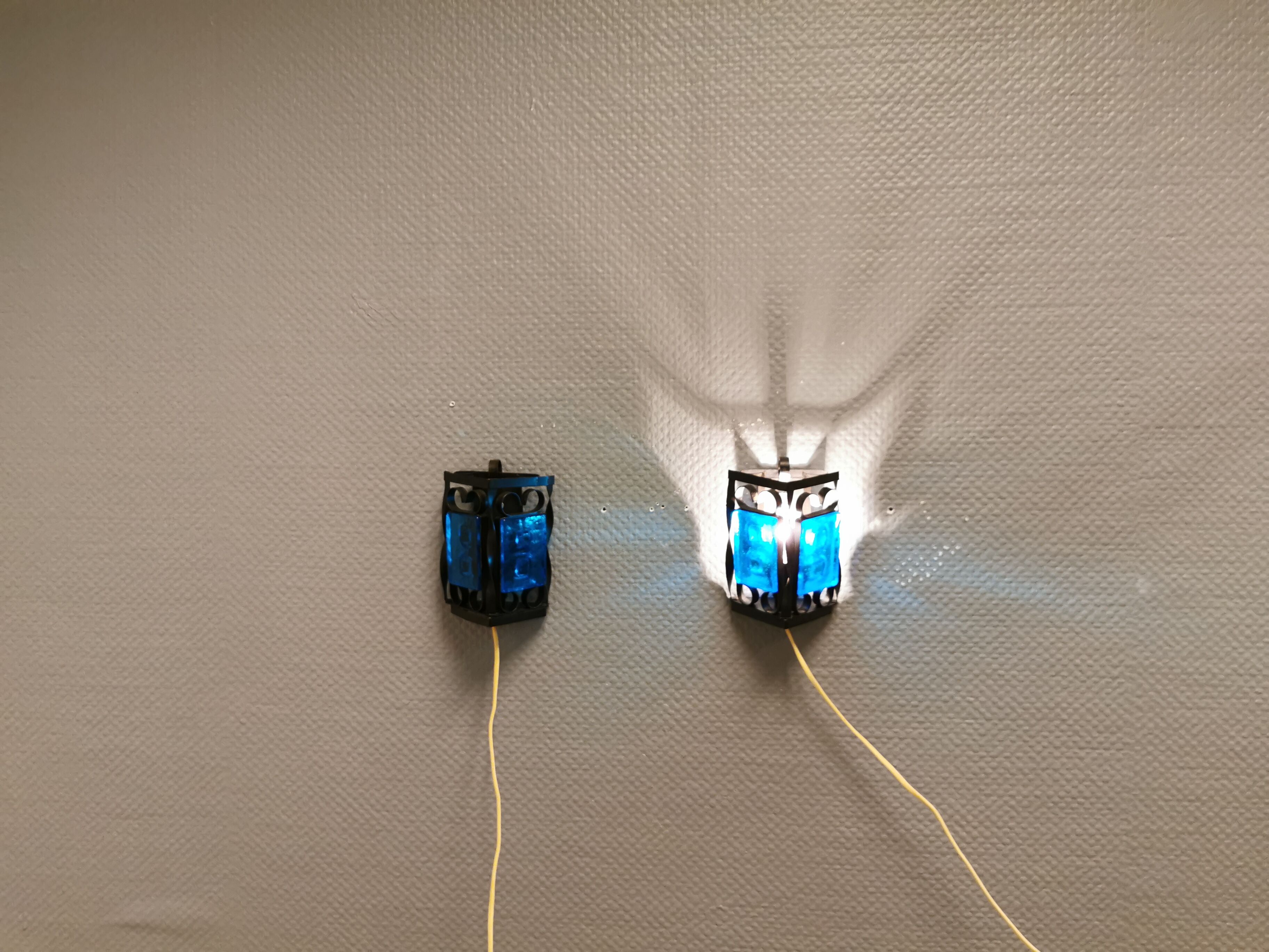 Wall lamps made of black cast iron and handmade thick pressed blue glass