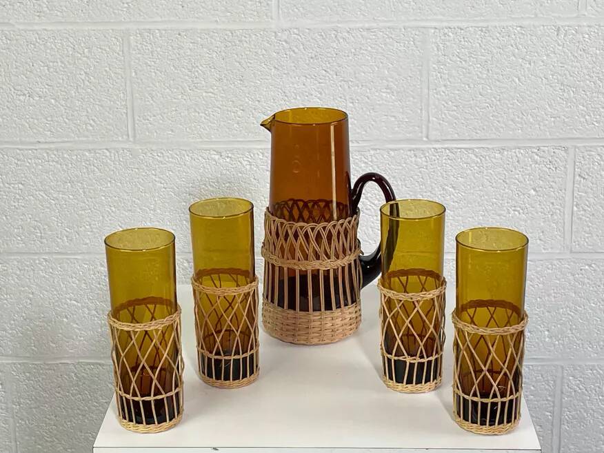 Vintage service for orangeade in amber glass and wicker.