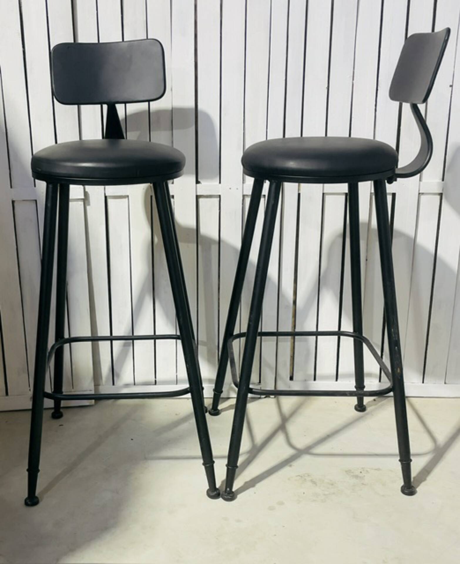 Pair of black bar stools in industrial and contemporary style.