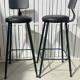 Pair of black bar stools in industrial and contemporary style.
