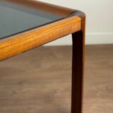 Square wooden coffee table with glass.