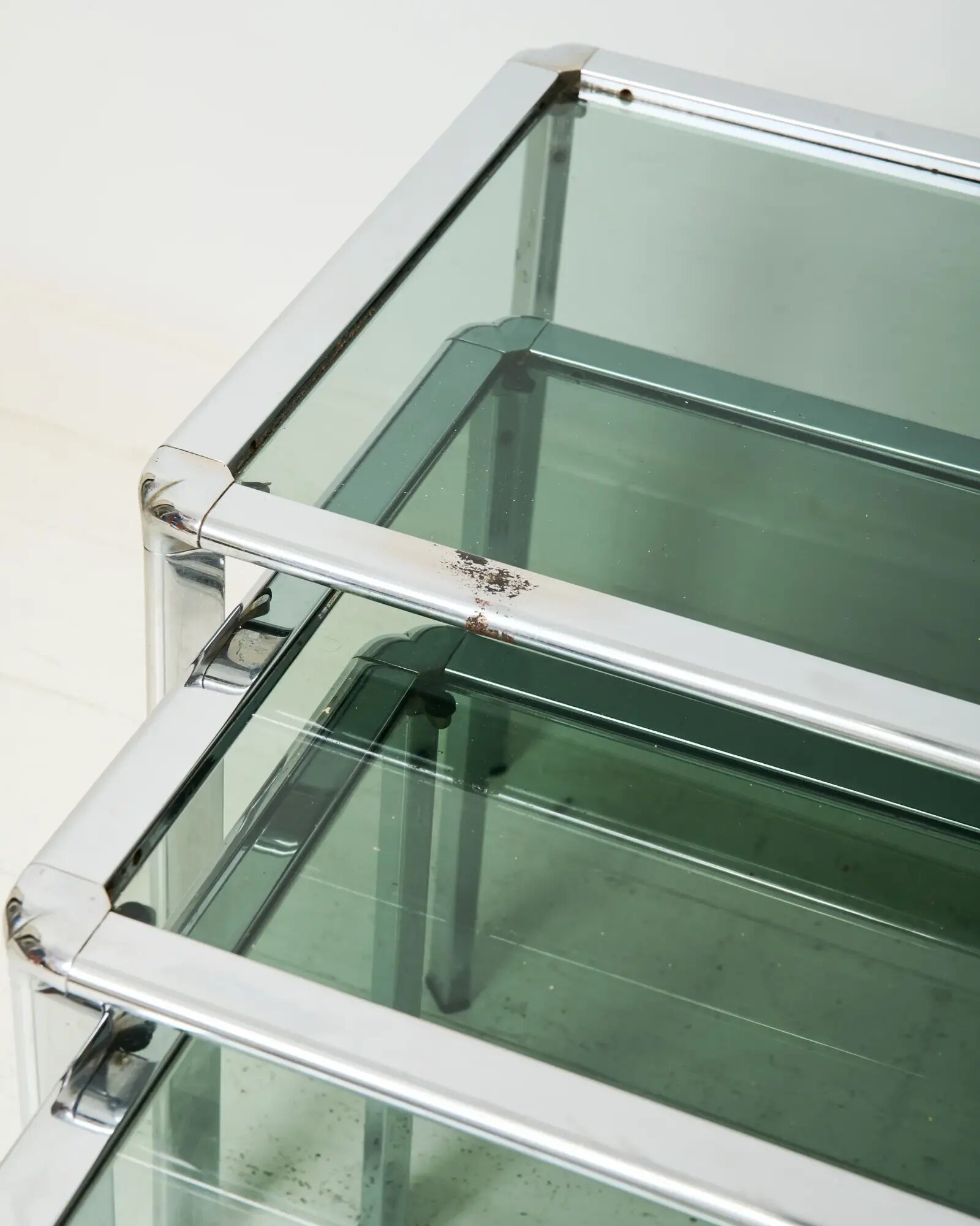 Nest tables in chrome and smoked glass, Italy, 1970s.
