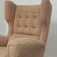 Beige wingback armchair and TVAR footrest, former Czechoslovakia.