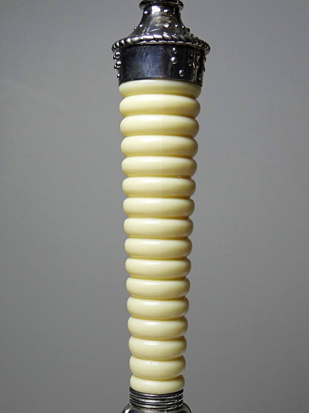 Pair of vintage candlestick holders in silver-plated metal with ivory-style plastic.
