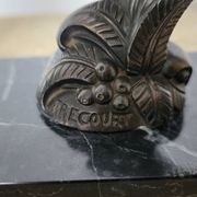 Pair of Art Deco bookends signed Frécourt, patinated metal & black marble