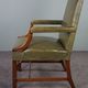 Elegant armchair and footrest in English green leather