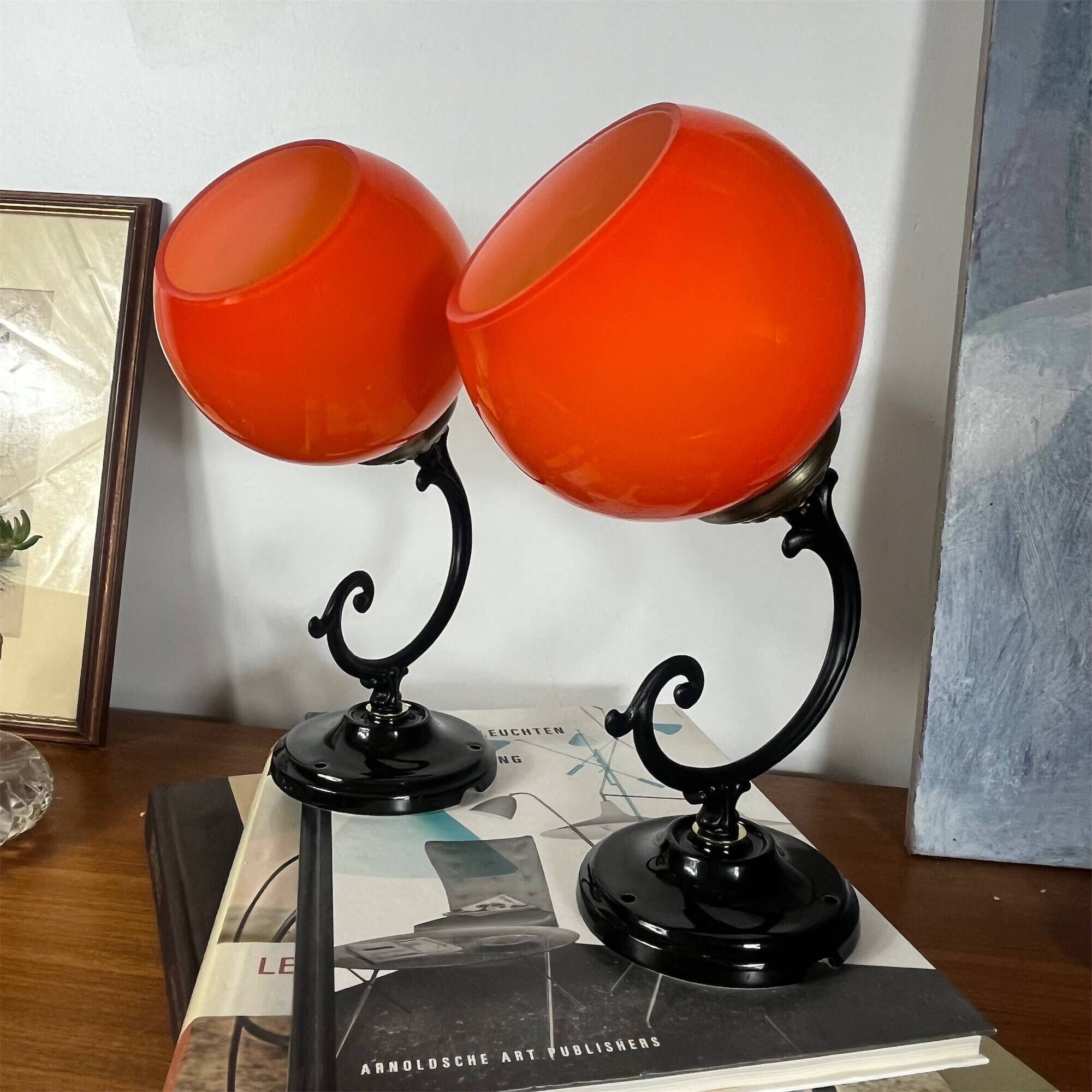 Pair of wall sconces with orange opaline globes and porcelain rose.