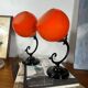 Pair of wall sconces with orange opaline globes and porcelain rose.