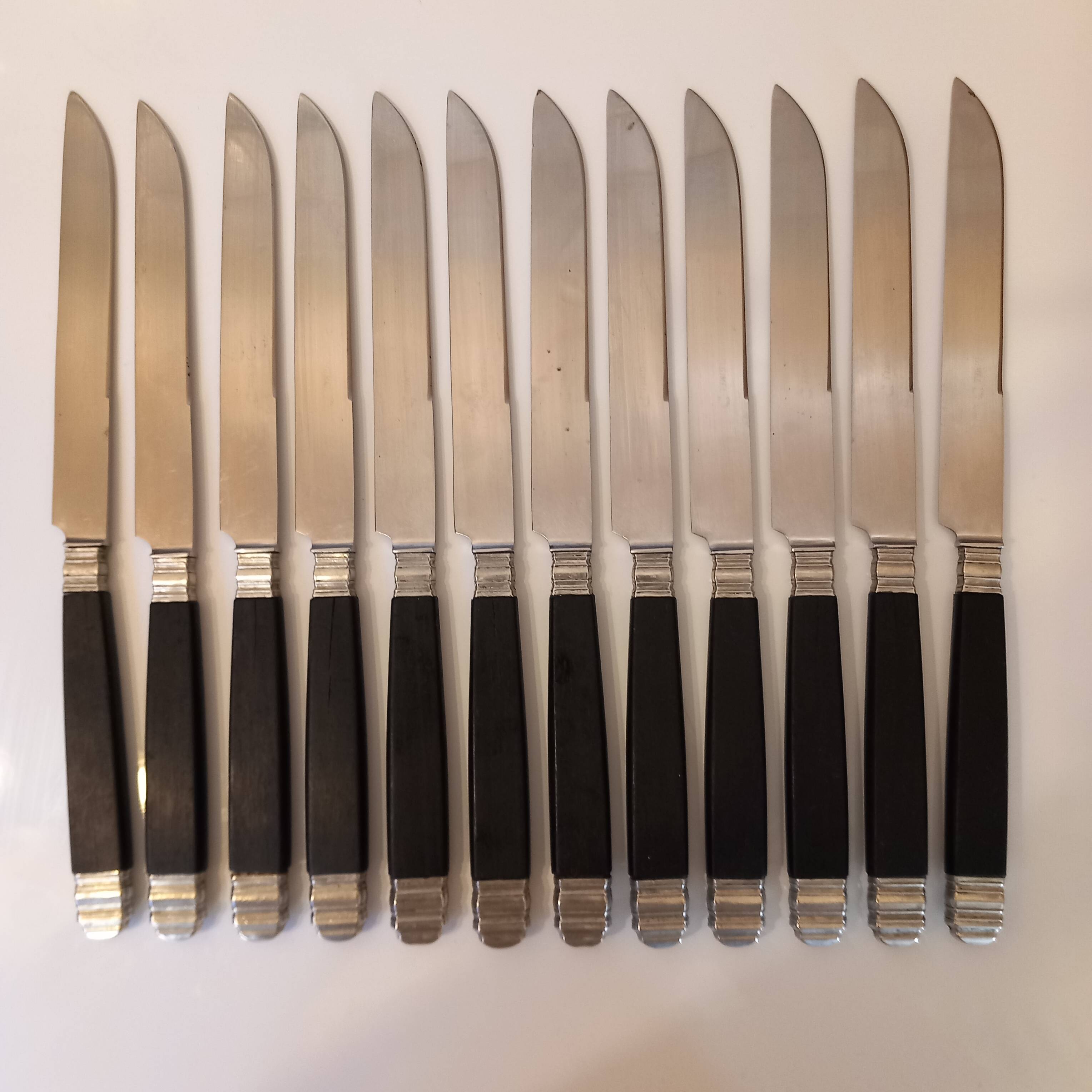 12 black Empire style table knives with silver ferrule Gimel
