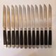 12 black Empire style table knives with silver ferrule Gimel