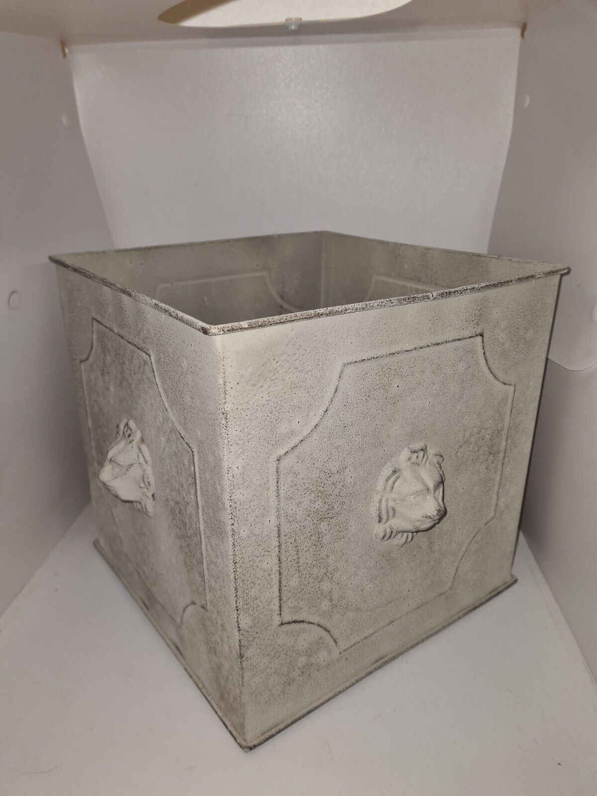 Square planter with a patinated iron lion's head