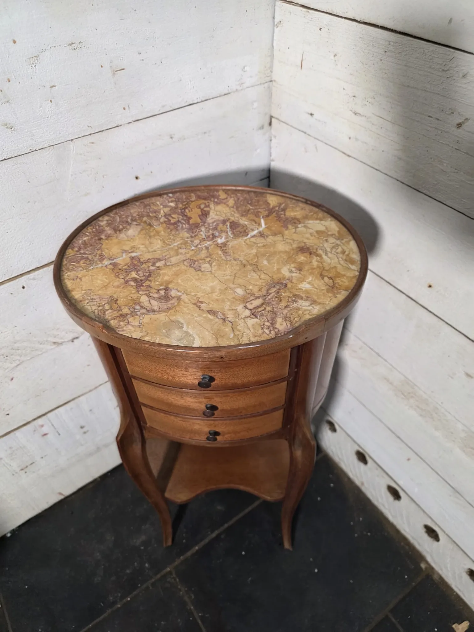 Oval bedside table in Louis XV style made of mahogany.
