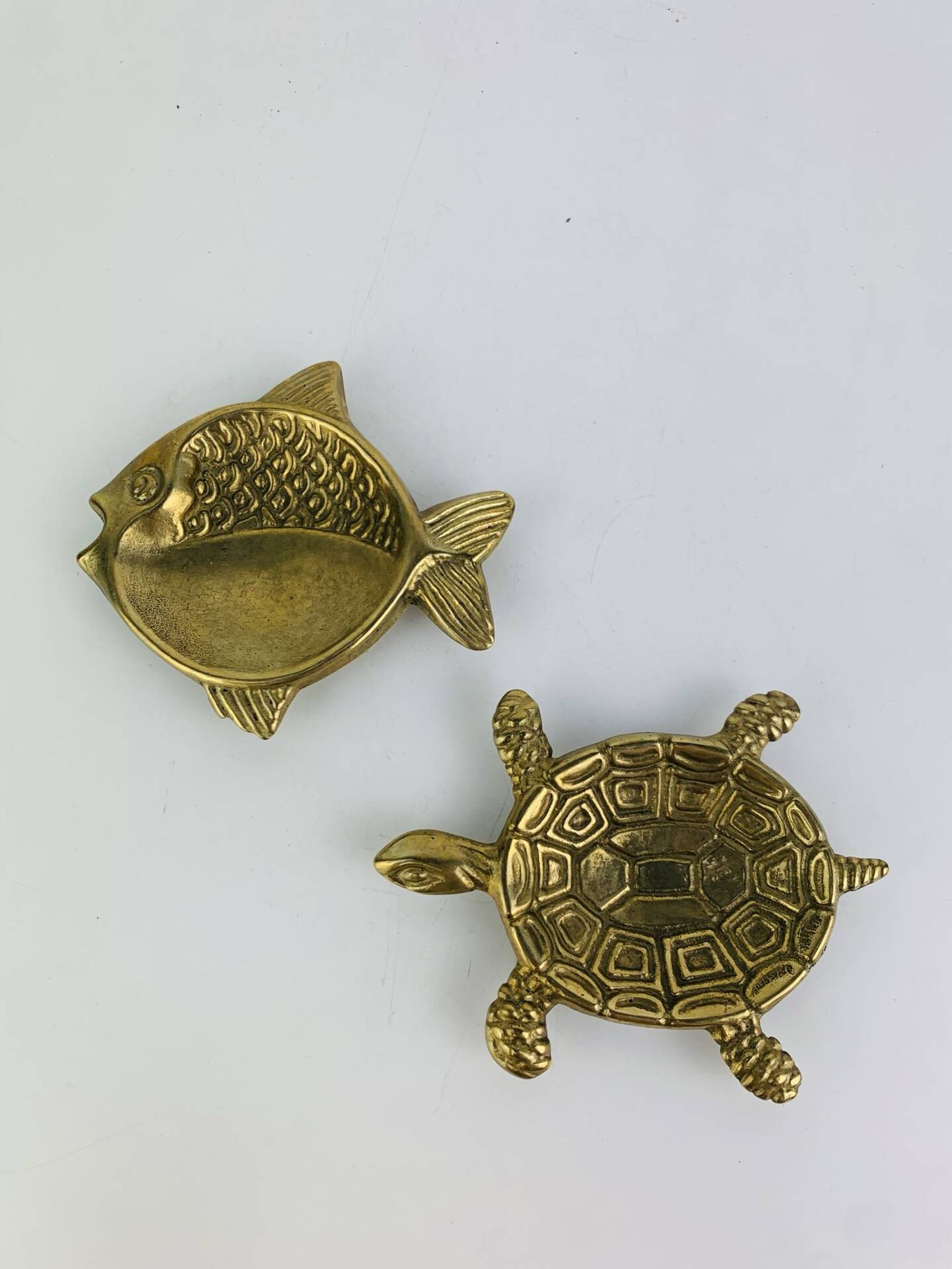 Pair of animal trinket trays in brass, fish and turtle.
