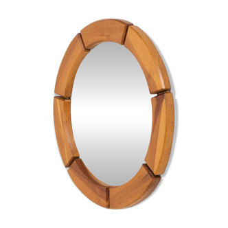 Sculptural wall mirror in solid pine