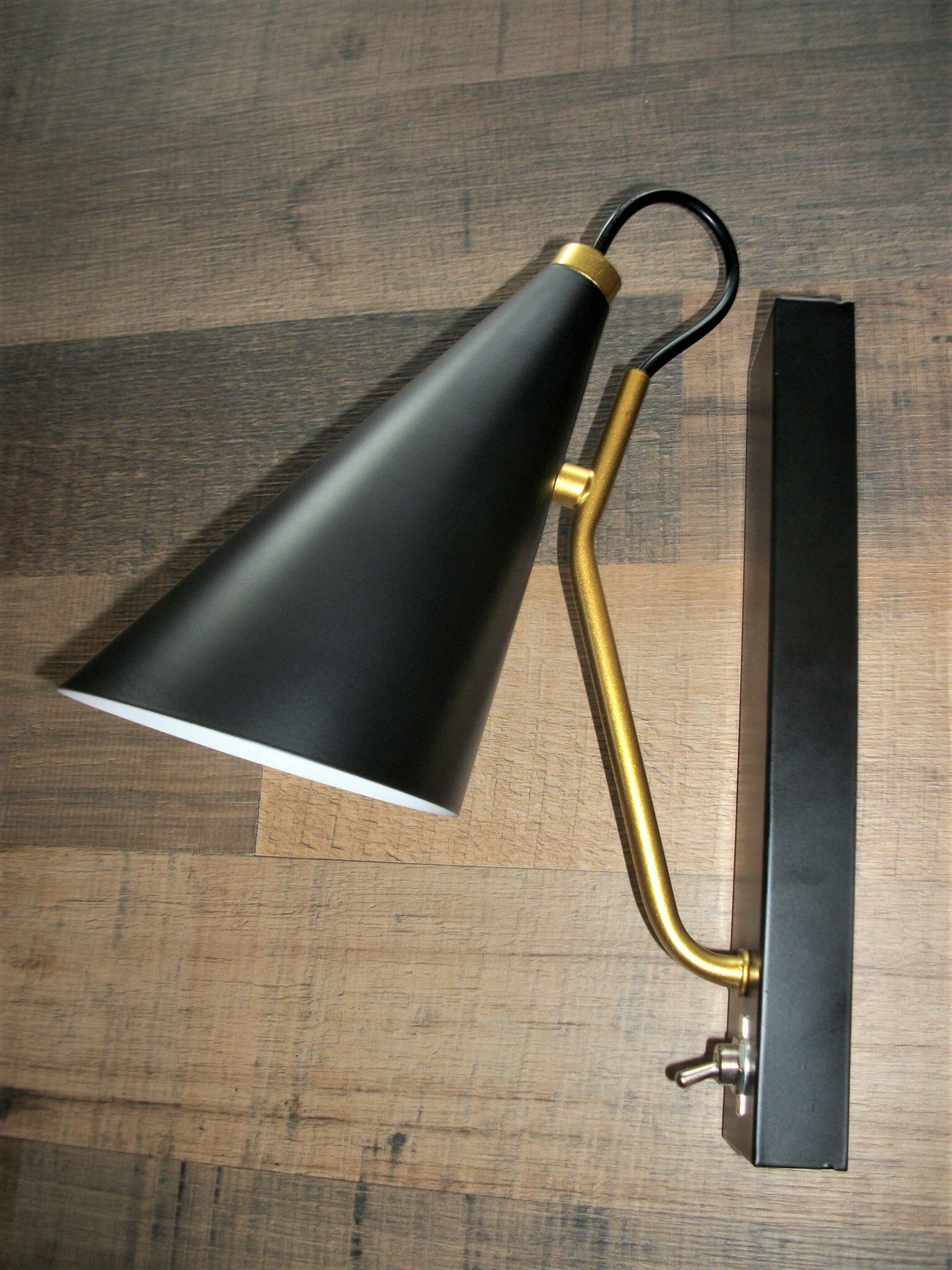 Pair of modernist sconces in black and gold metal