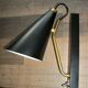 Pair of modernist sconces in black and gold metal