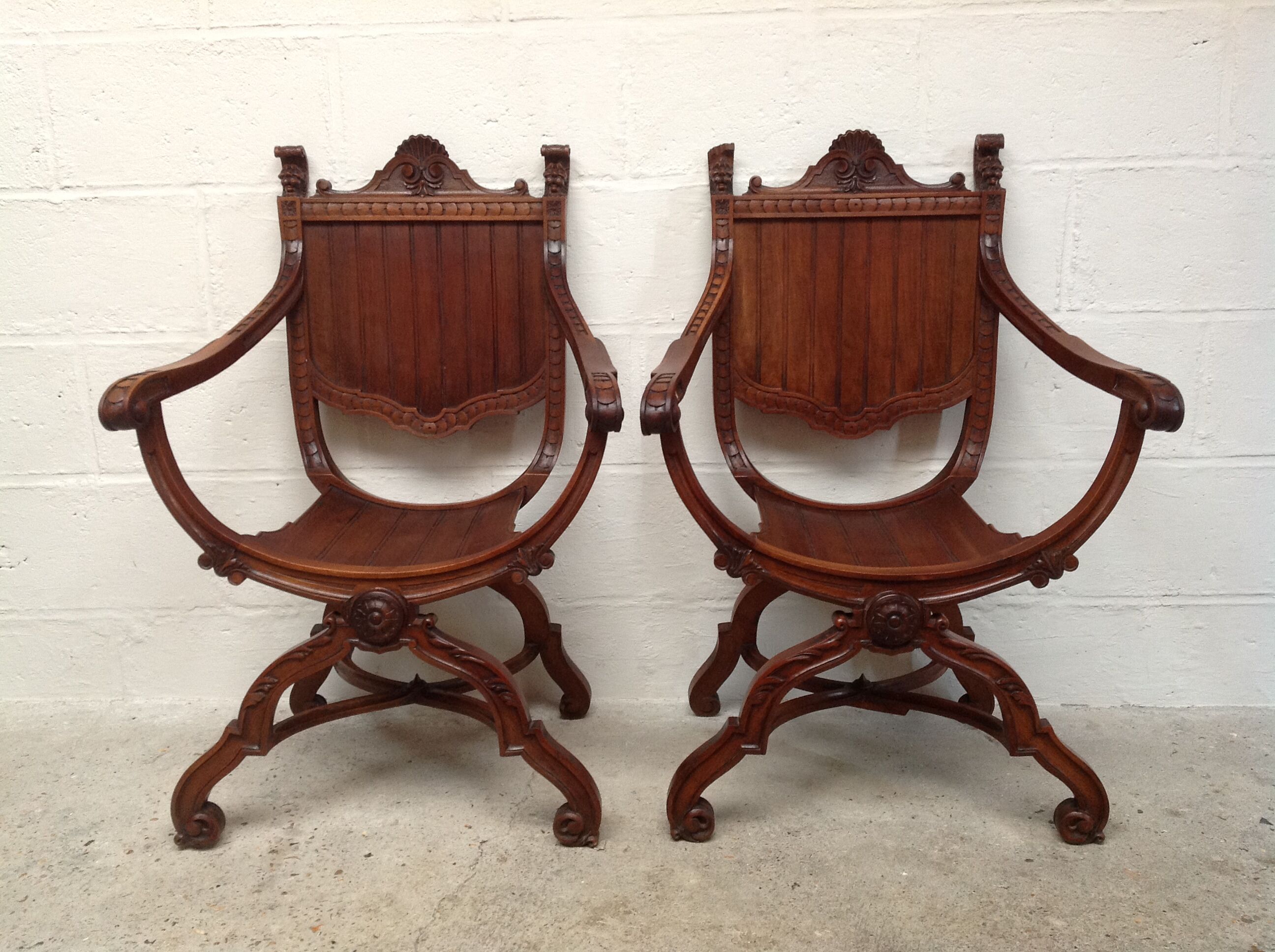 Pair of antique armchairs curules called Dagobert in carved wood
