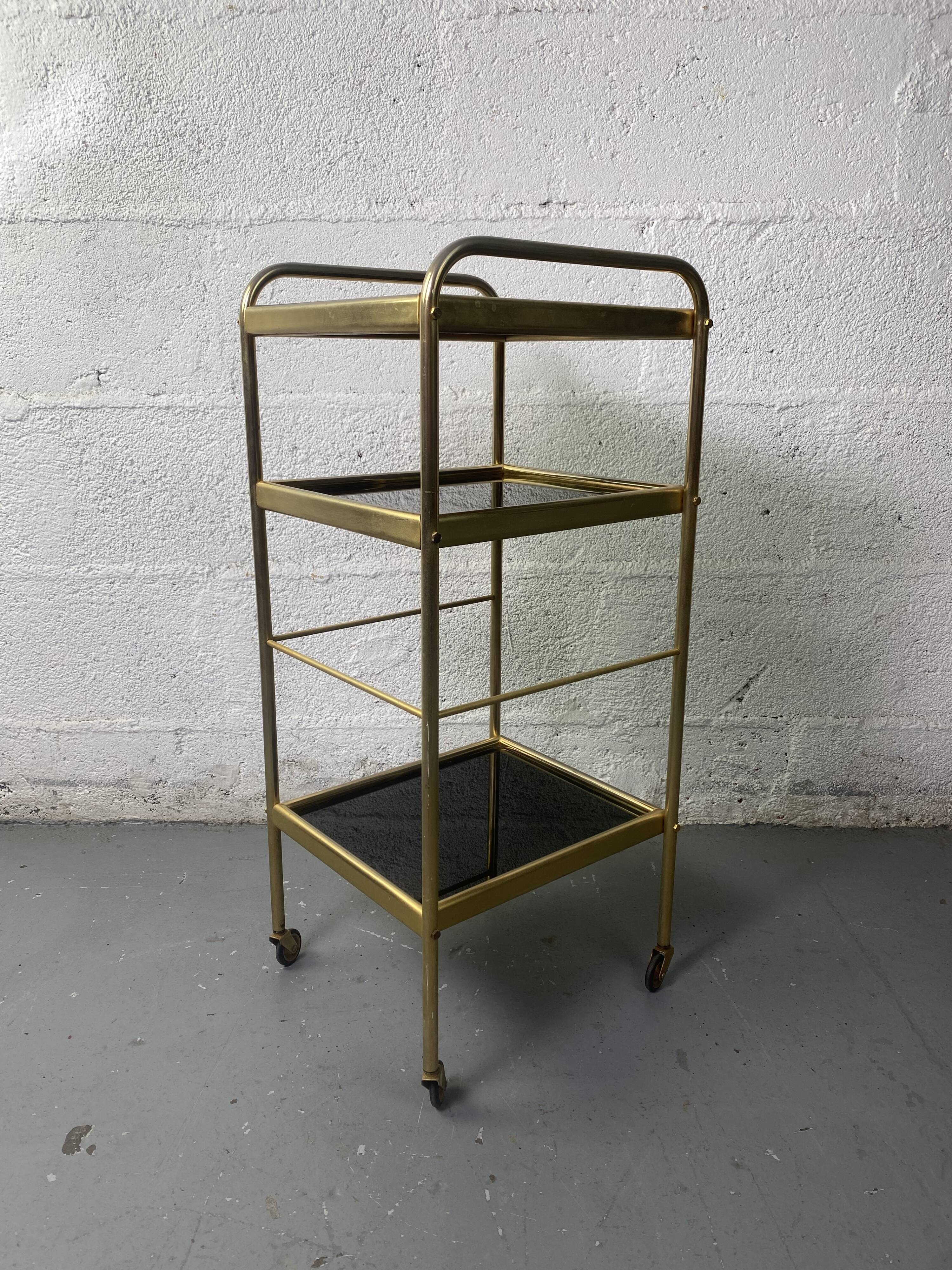 Small rolling trolley in brass and black plastic