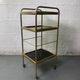 Small rolling trolley in brass and black plastic