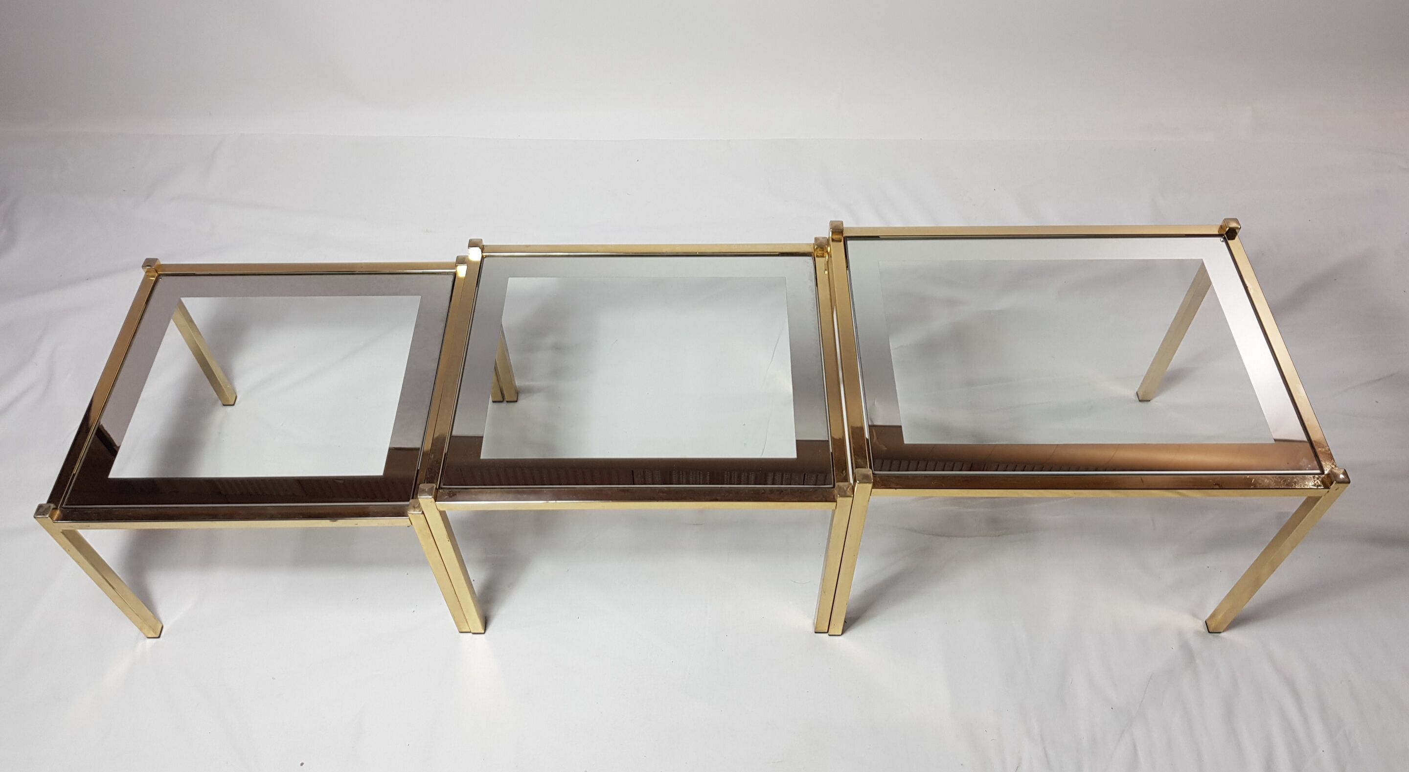 Three trundle tables gilded brass and silver 60s