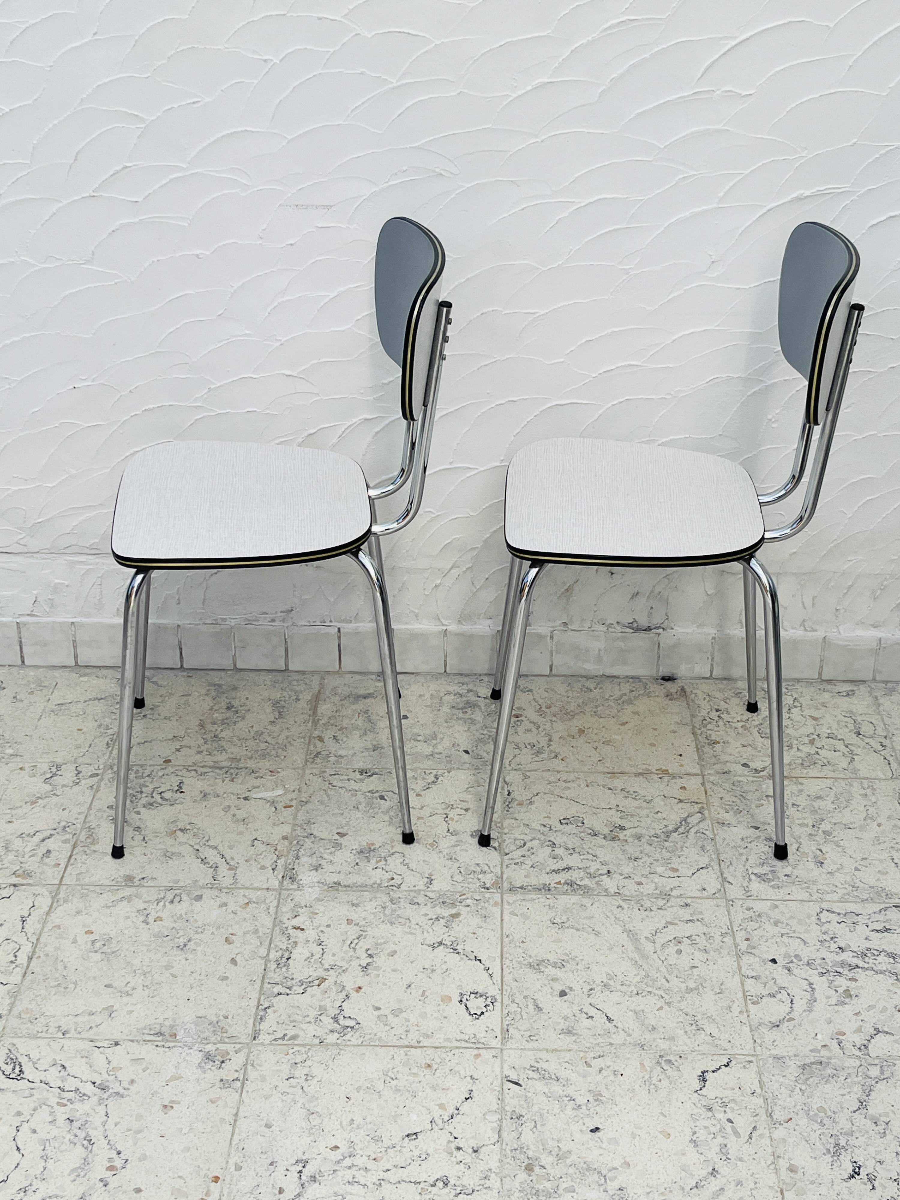 Set of two vintage grey Formica and chrome chairs.