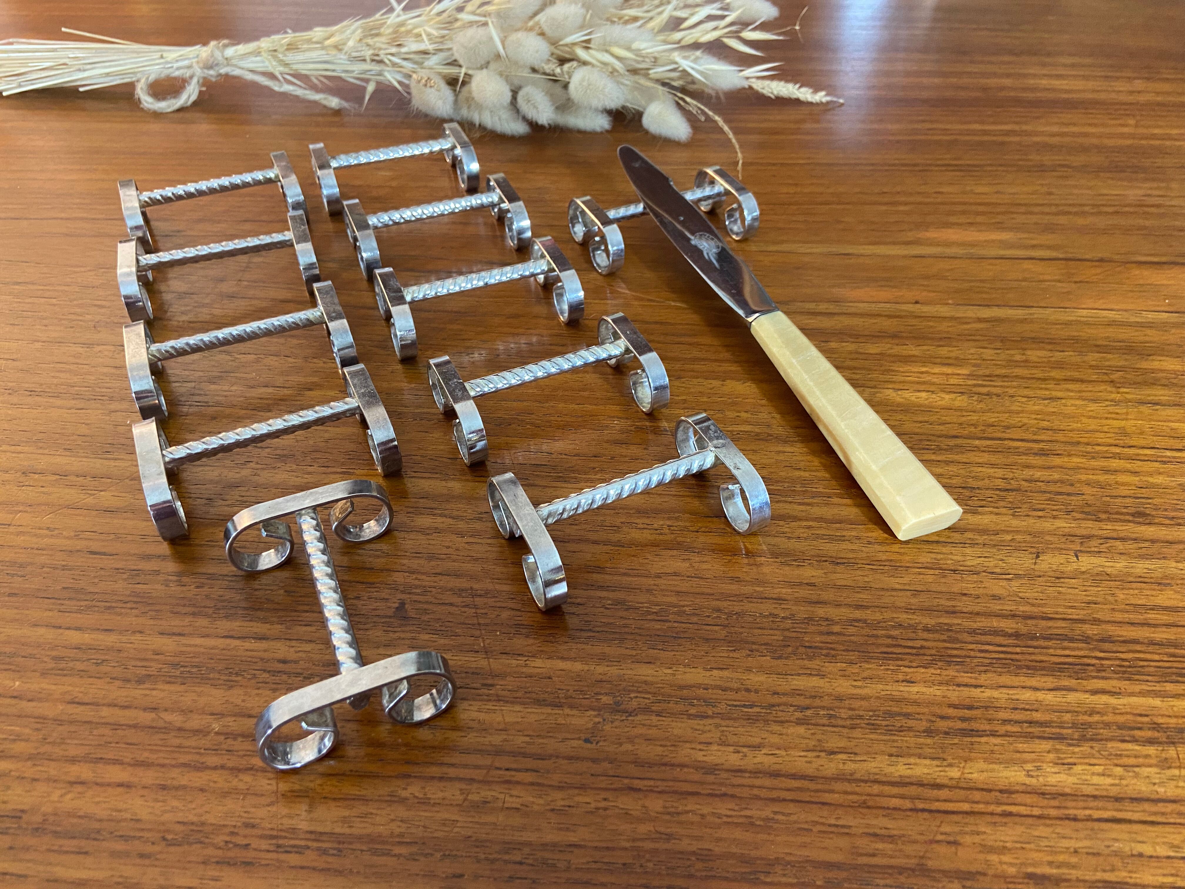 Set of 11 silver-plated metal knife holders, 1960