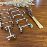 Set of 11 silver-plated metal knife holders, 1960