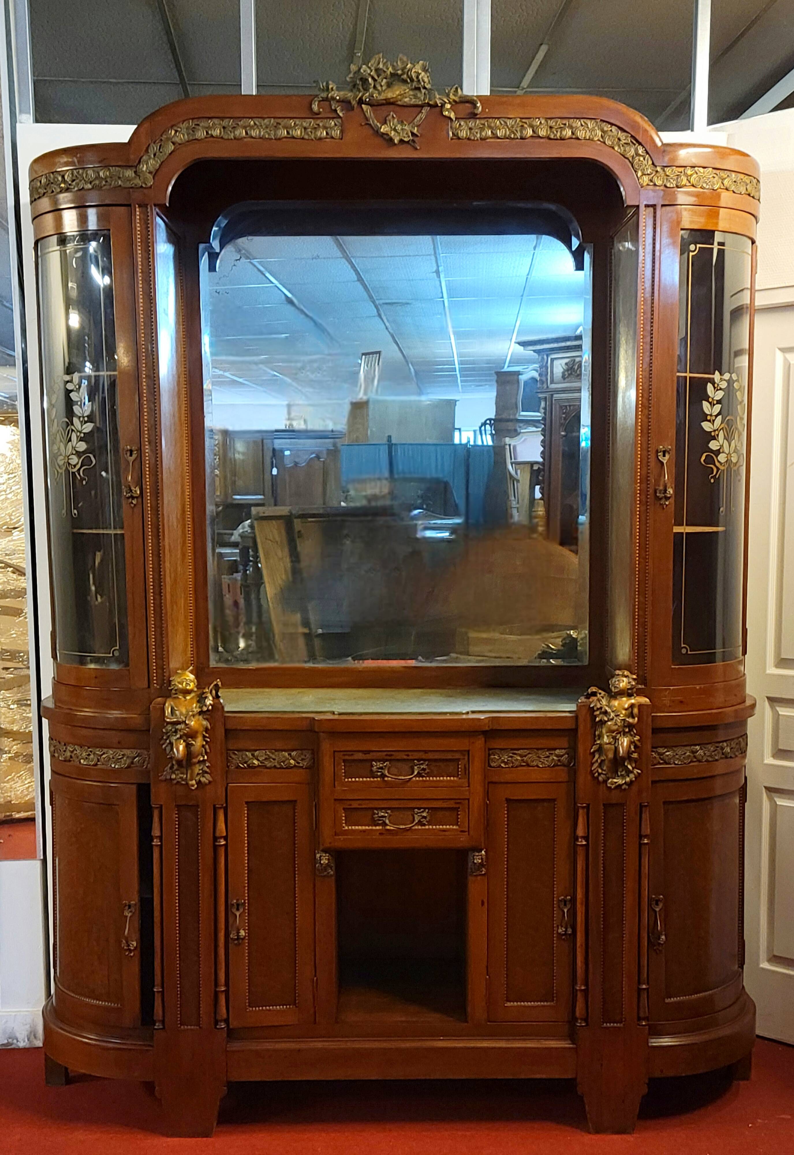 Empire style half-moon shaped mahogany bookcase with putti