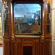 Empire style half-moon shaped mahogany bookcase with putti