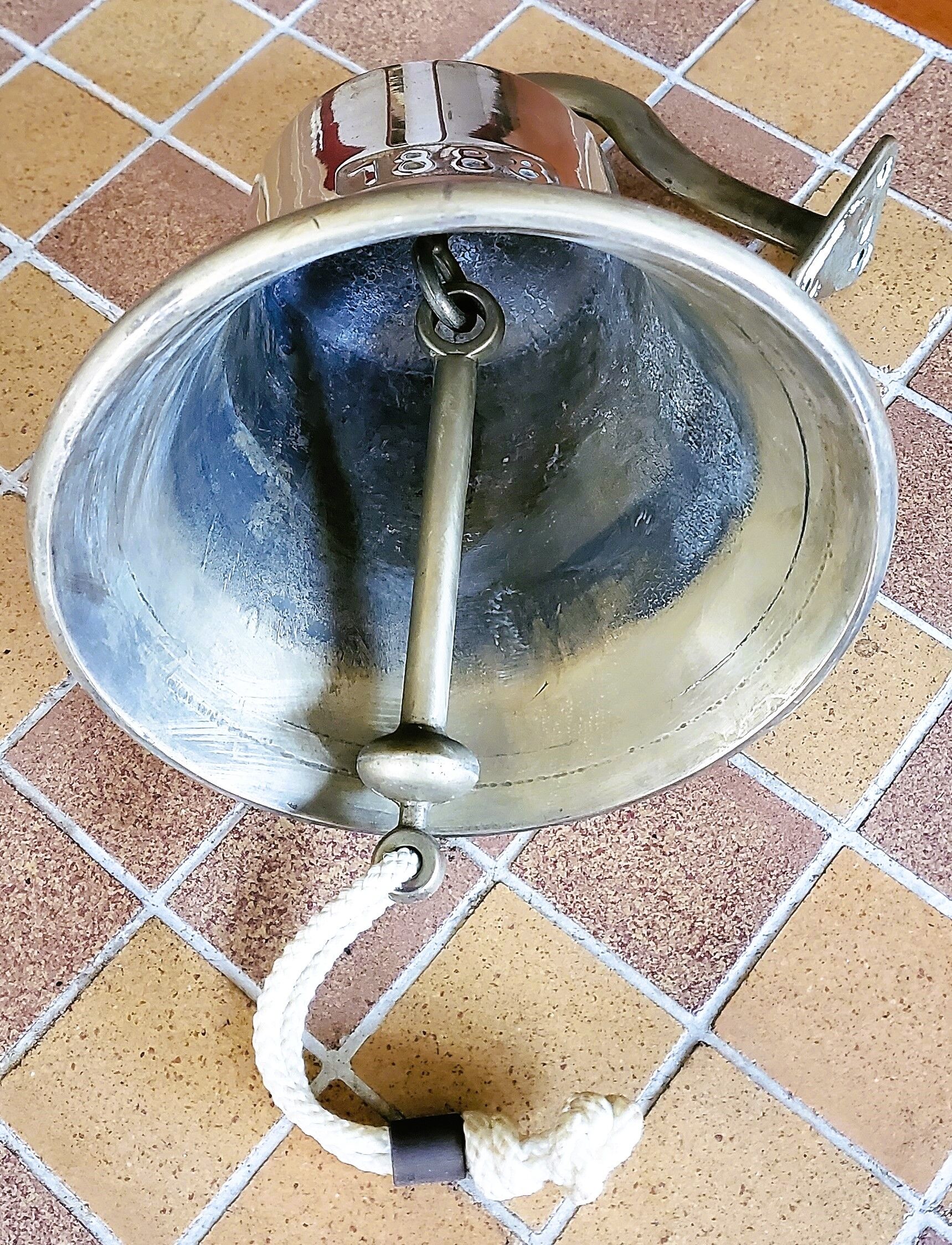 Polished brass bell with its stem