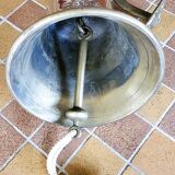 Polished brass bell with its stem