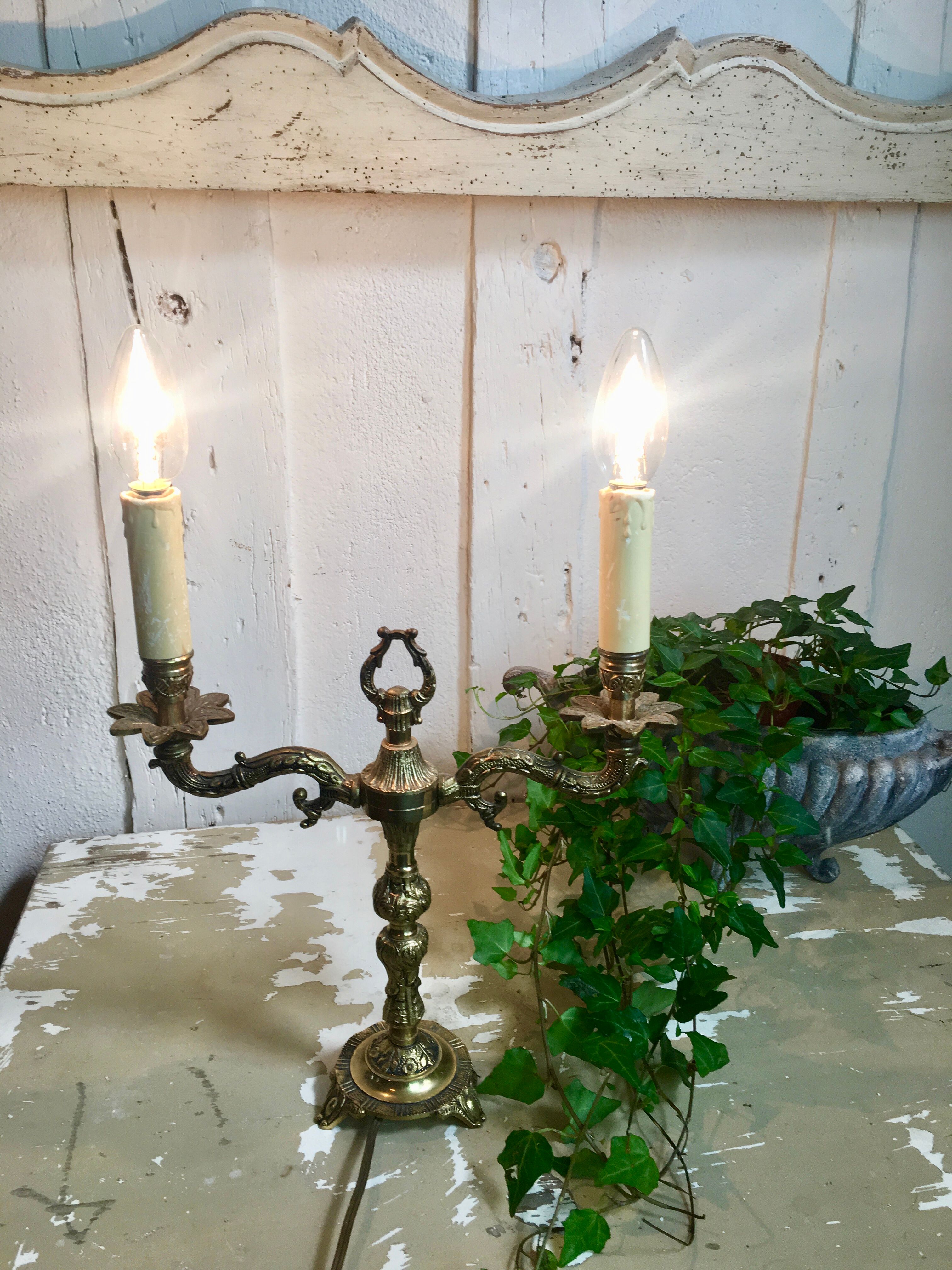 Pair of Louis XVI style double lamps in gilded bronze