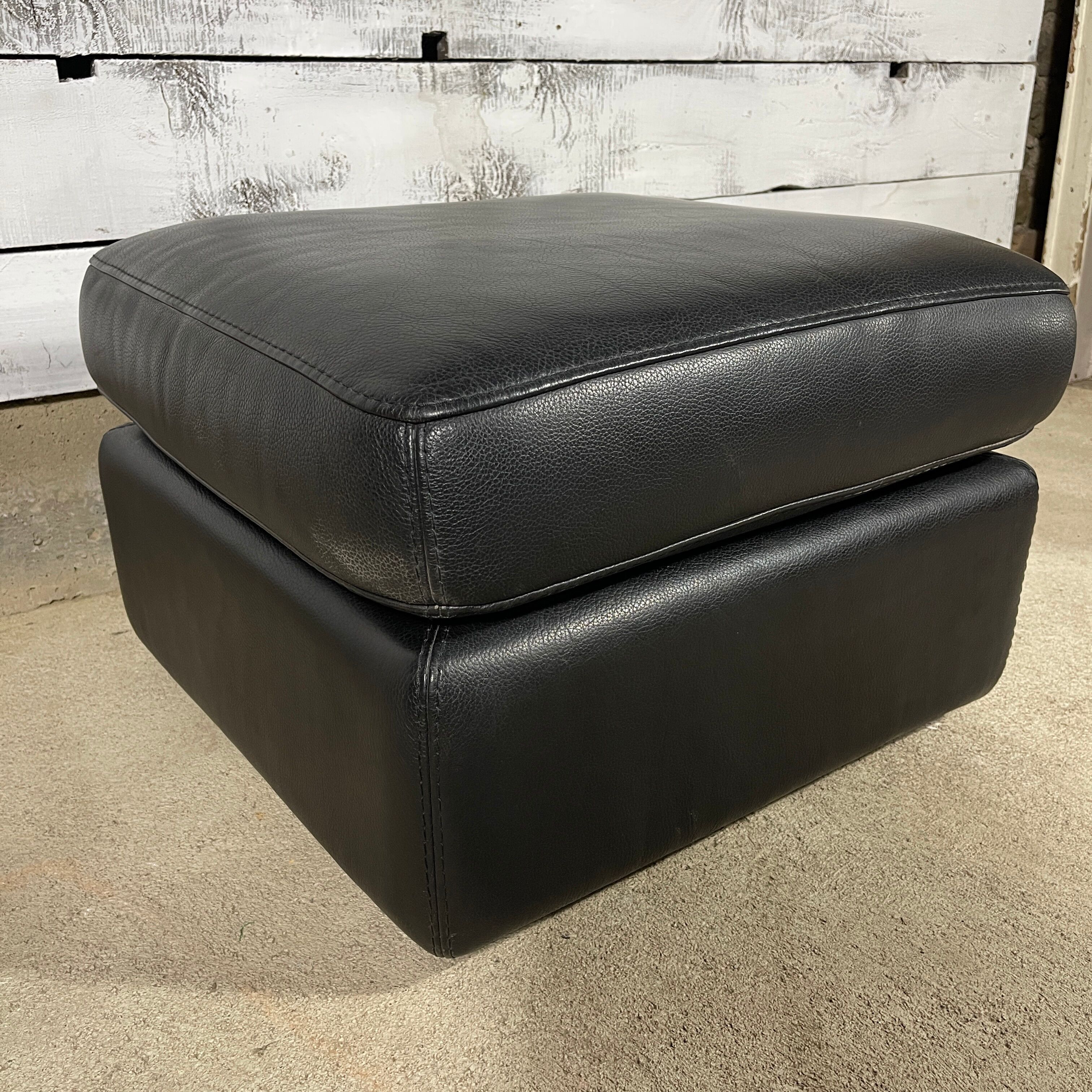 Black leather pouf